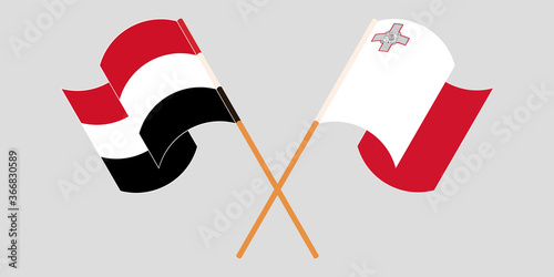 Crossed and waving flags of Malta and Yemen