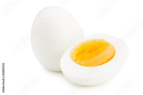 Single whole boiled egg with halved egg isolated on a white background photo