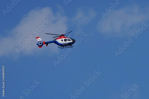 Police helicopter under a blue sky in summer