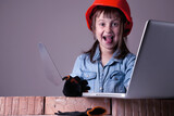 Funny portrait of happy cute young female construction engineer designs and builds a house. Humorous image.