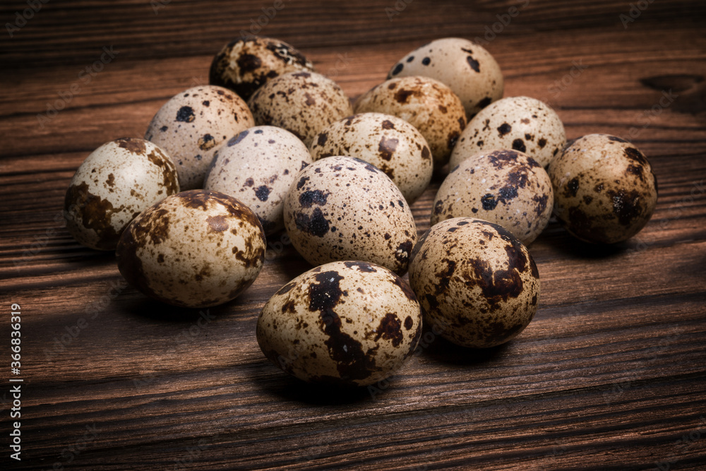 Quail eggs on a dark brown wooden background Quail eggs on a dark brown wooden background