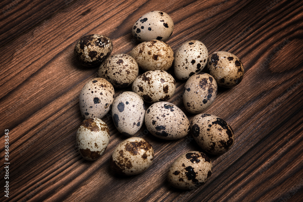 Quail eggs on a dark brown wooden background Quail eggs on a dark brown wooden background