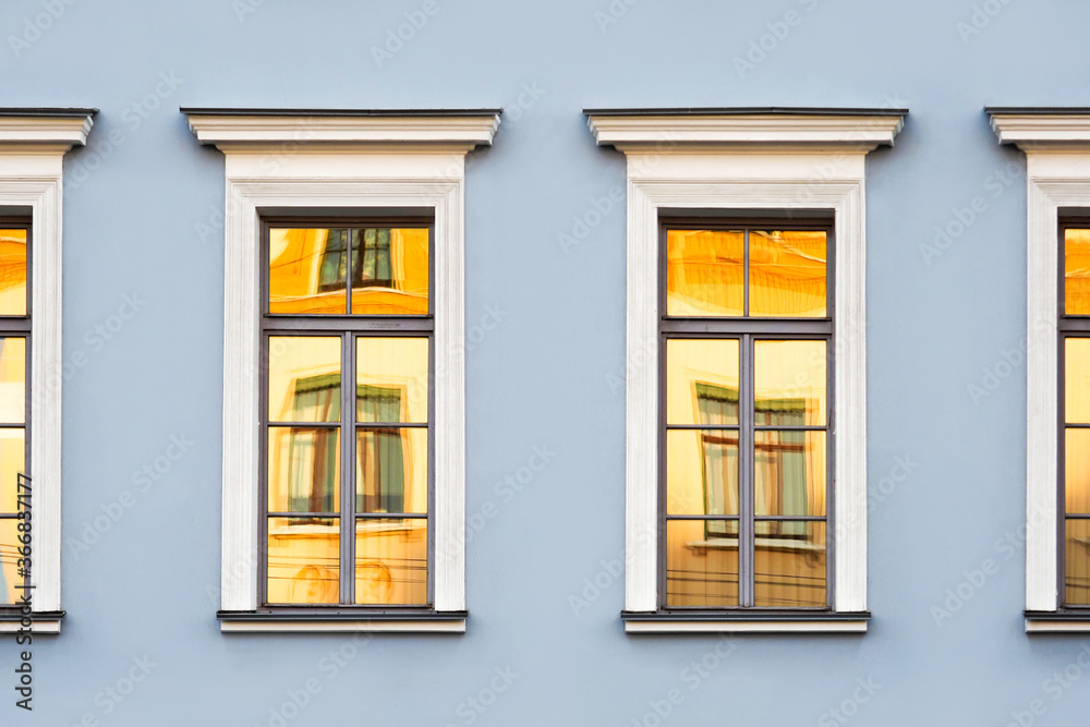 Reflections of old buildings in the windows, classic urban architecture background