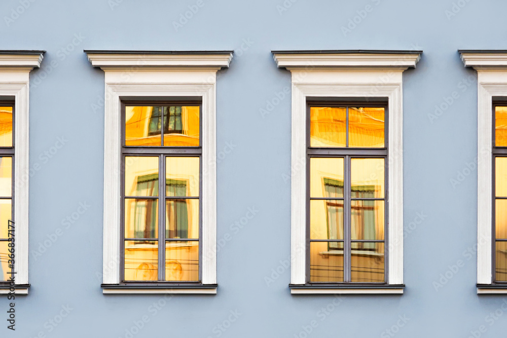 Reflections of old buildings in the windows, classic urban architecture background Reflections of old buildings in the windows, classic urban architecture background