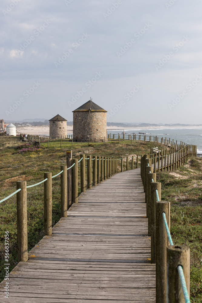 Windmills and coastal path at beach Praia da Apúlia, Esposende, Portugal