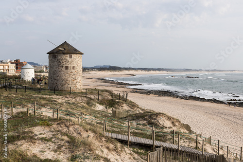 Windmills and coastal path at beach Praia da Apúlia, Esposende, Portugal