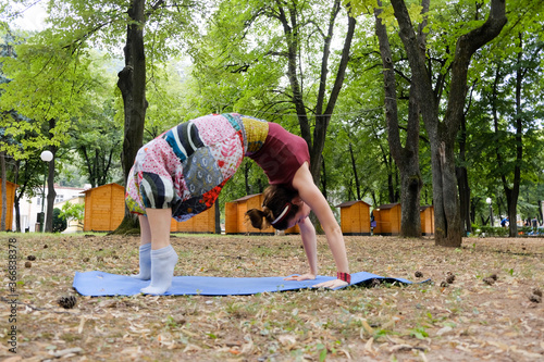 Young woman doing yoga exercise in the park