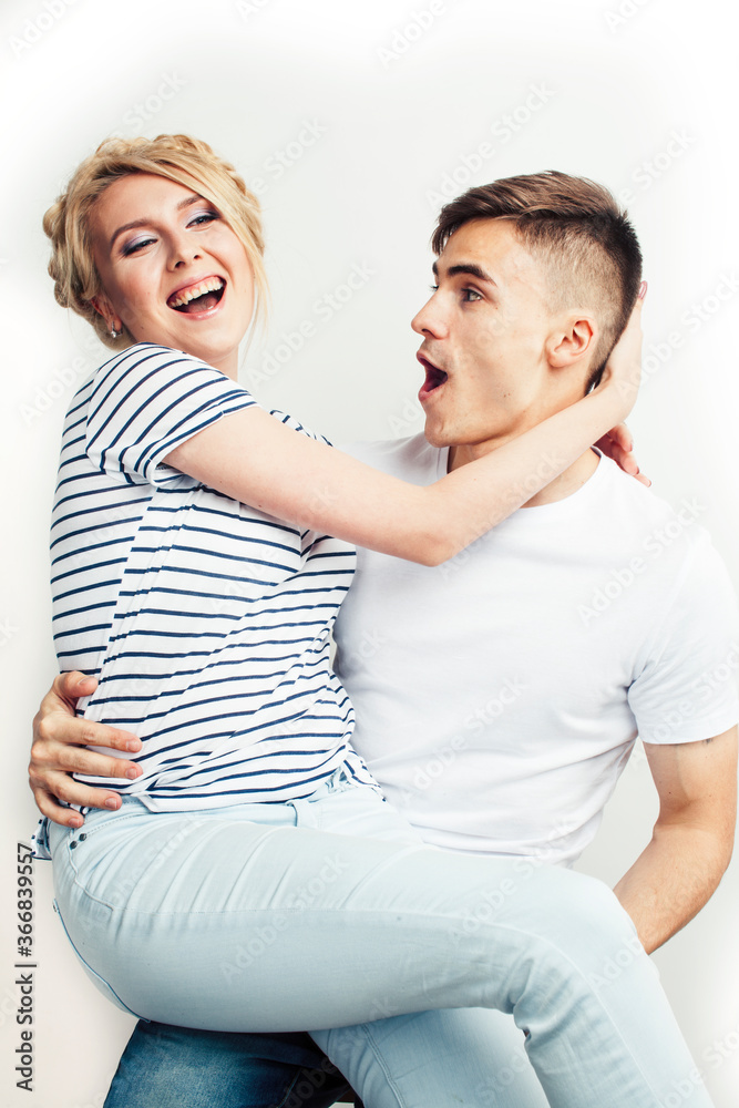 young pretty teenage couple, hipster guy with his girlfriend happy smiling and hugging isolated on white background, lifestyle people concept young pretty teenage couple, hipster guy with his girlfriend happy smiling and hugging isolated on white background, lifestyle people concept