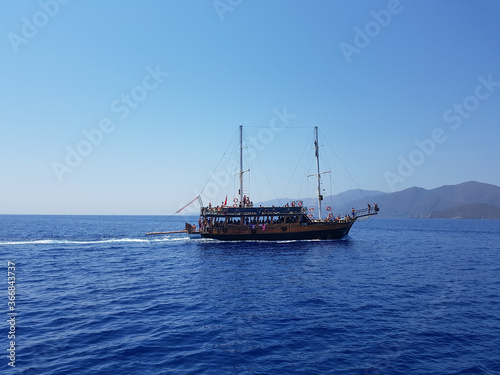 Pirate ship sails the sea, landscape, mountains