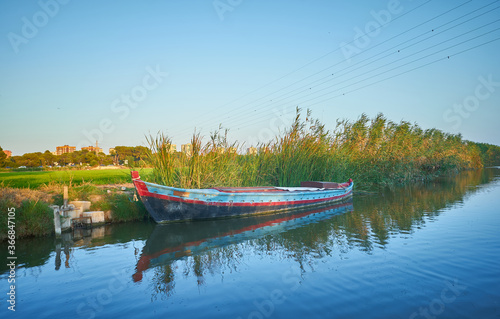Fototapeta Naklejka Na Ścianę i Meble -  Albufera canal boats in El Palmar de Valencia Spain