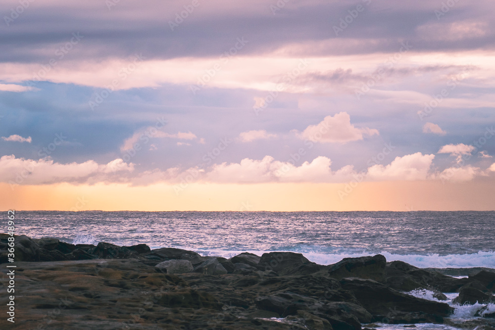 Sunrise over rocks at beach, landscape, room for copy, room for text, background landscape image