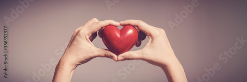 Woman holding red heart, health insurance, donation, happy charity volunteer concept, world mental health day, world heart day