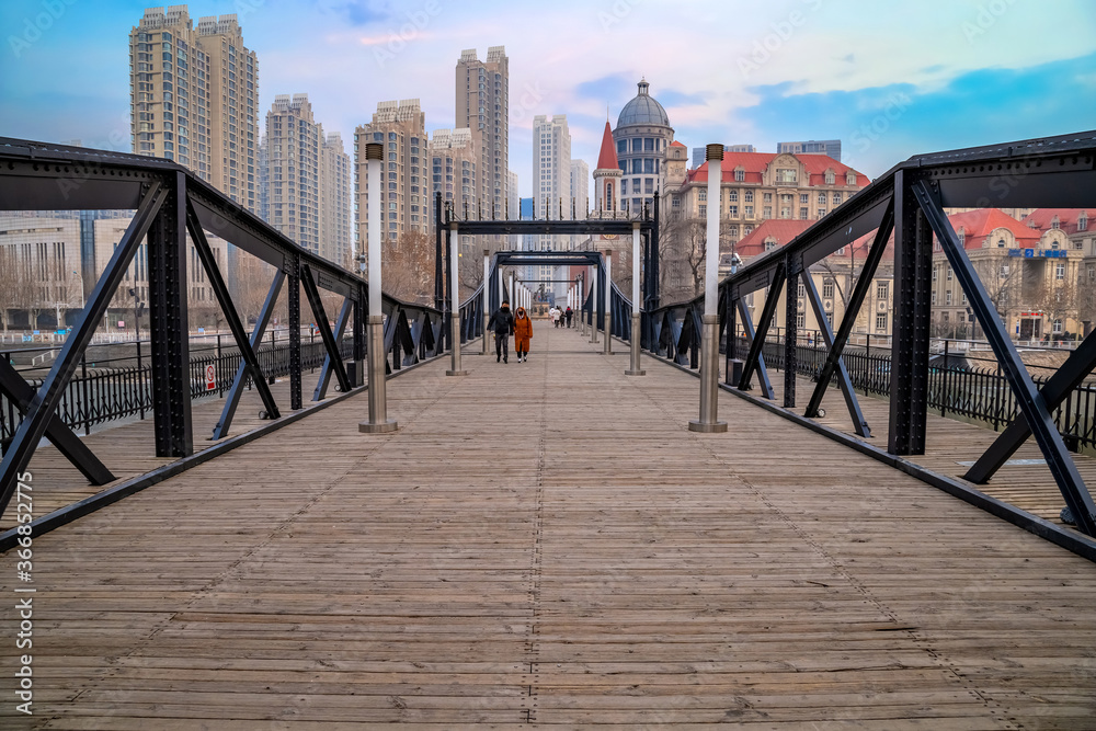 Tianjin, China - Jan 16 2020: Tianjin pedestrian wooden bridge over Haihe river in Nankai district Tianjin, China - Jan 16 2020: Tianjin pedestrian wooden bridge over Haihe river in Nankai district
