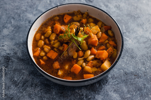 plant-based food, vegan sweet potato and pumpkin stew with butter beans and roasted veggies