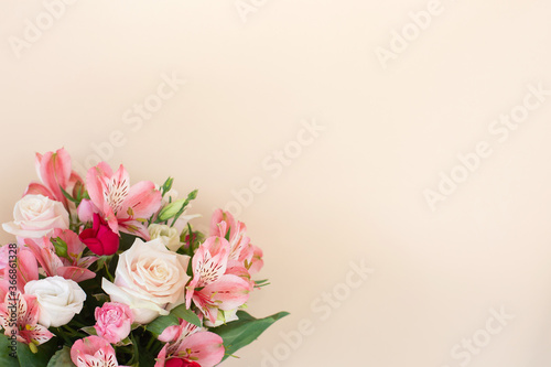 Beautiful bouquet of rose and alstroemeria flowers on light background. © ukrolenochka