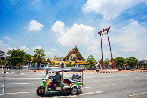 Tuk Tuk , Thai taxi around The giant swing (Sao Ching Cha) and Wat Suthat temple in Bangkok, Thailand