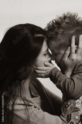 Portrait Young mother kissing her little son
