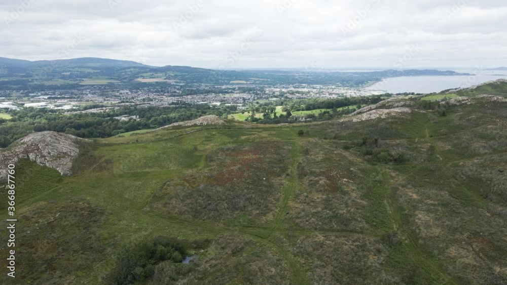 Revealing Shot Of The Scenic Bray Town Landscape And Golf Course From The Bray Head Mountain In Wicklow, Ireland - aerial drone Revealing Shot Of The Scenic Bray Town Landscape And Golf Course From The Bray Head Mountain In Wicklow, Ireland - aerial drone