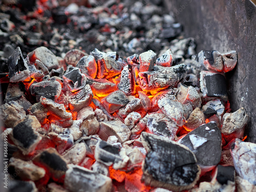 Abstract background of the glowing hot charcoal in the barbecue grill Abstract background of the glowing hot charcoal in the barbecue grill