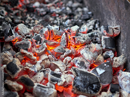 Abstract background of the glowing hot charcoal in the barbecue grill