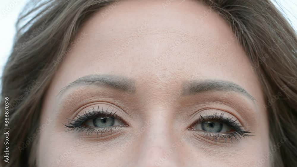 Close up woman eyes with glamour makeup looking into camera