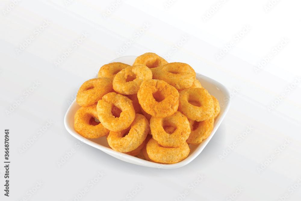 Pile of crispy Corn ring, Cream & Onion snack (Fryums - Frymus) in white dish isolated on white background, Sweet brekfast cereal rings - Image