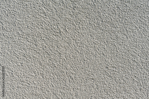 texture of an uneven painted beige rough wall