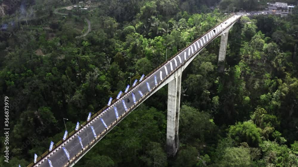 Aerial Shot Of Car And Motorcycle Traffic On Breathtaking Bridge In Bali Aerial Shot Of Car And Motorcycle Traffic On Breathtaking Bridge In Bali