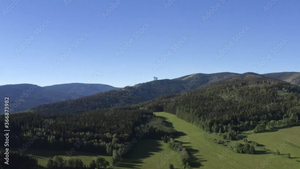 Scenic aerial 4k shot of a mountainous woodland panorama in summer in Dolní Morava, Czech Republic, with forests, green fields, hills and blue cloudless sky above. Picturesque countryside in Czechia. Scenic aerial 4k shot of a mountainous woodland panorama in summer in Dolní Morava, Czech Republic, with forests, green fields, hills and blue cloudless sky above. Picturesque countryside in Czechia.