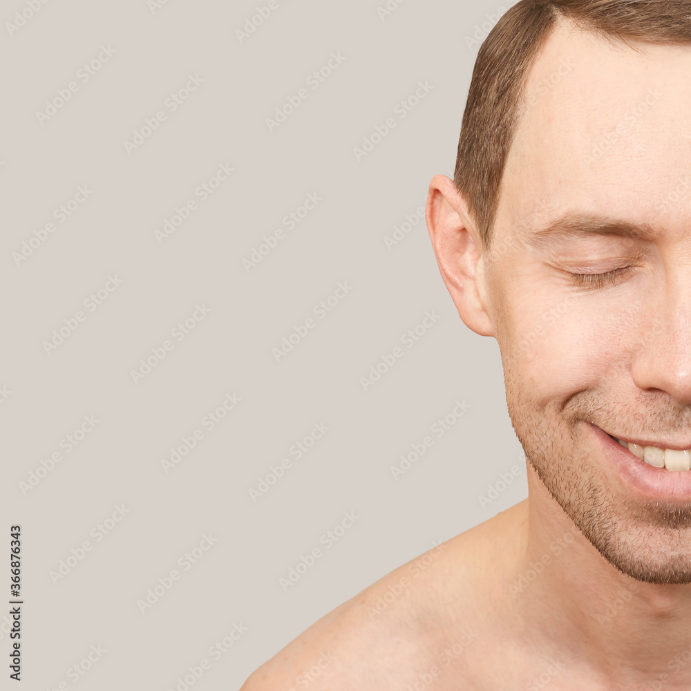 Obraz premium Smiling white man. Beauty cosmetology portrait. Closed eyes. Smile male person. Dream about travel. Clean skin procedure. Laugh handsome adult. Beige background. Calm relax concept.