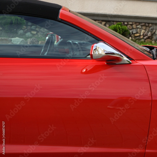 Red American classic muscle car cabriolet right door close up © Ilya