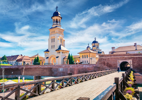 Sunny morning view of bell tower of Reunification Cathedral, Fortified churches inside Alba Carolina Fortress. Stunning summer cityscape of Alba Iulia, Romania, Europe. Traveling concept background..