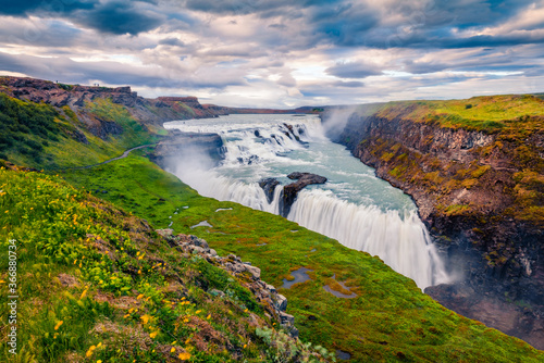 Dramatic summer view of popular tourist destination - Gullfoss waterfall. Breathtaking evening scene of Hvita river. Colorful outdoor scene of Iceland, Europe. Traveling concept background.