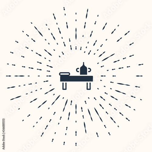 Grey Massage table with oil icon isolated on beige background. Abstract circle random dots. Vector.