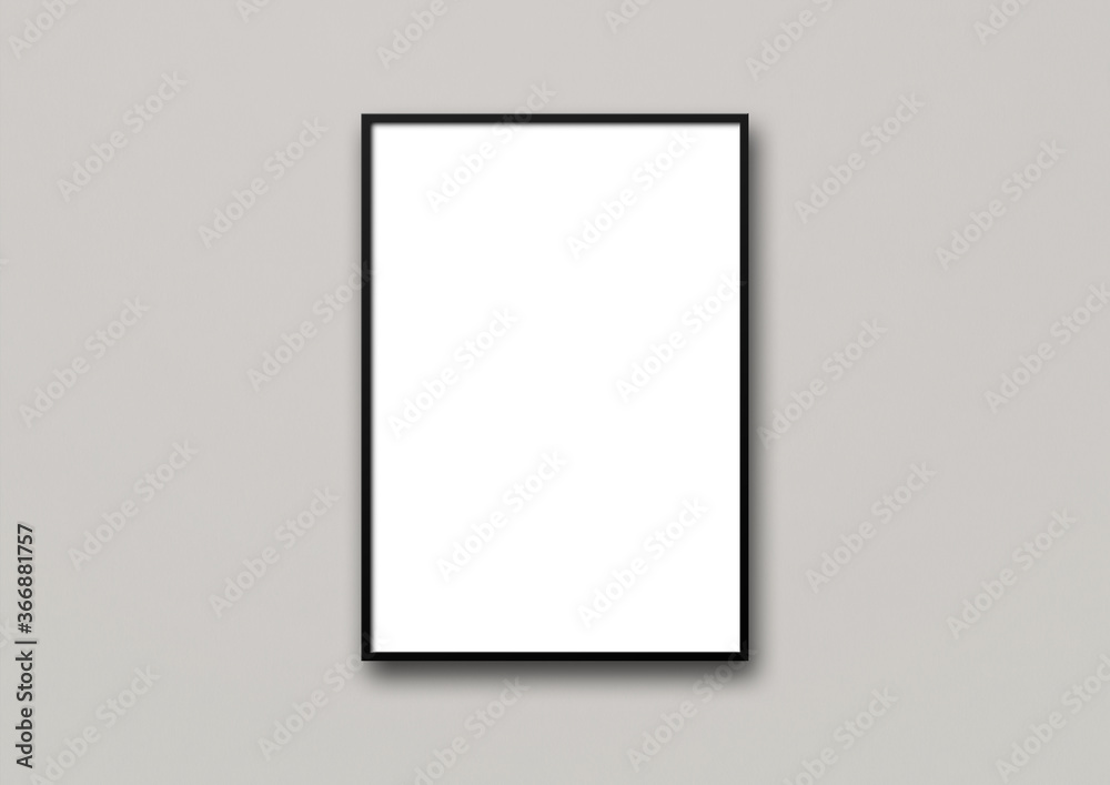 Black picture frame hanging on a light grey wall Black picture frame hanging on a light grey wall