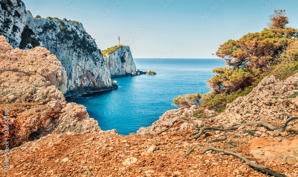 Bright morning view of Cape Lefkatas with old lighthouse. Superb spring seascape of Ionian Sea. Beautiful outdoor scene of Lefkada island, Greece, Europe. Traveling concept background..