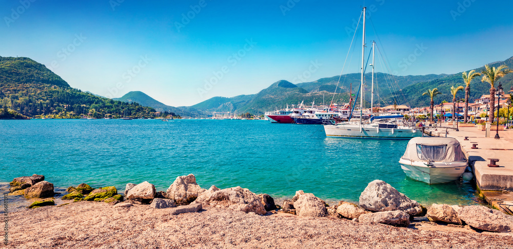 Fototapeta premium Panoramic morning view of port Nydri. Stunning spring seascape of Ionian Sea. Bright outdoor scene of Lefkada island, Greece, Europe. Traveling concept background.