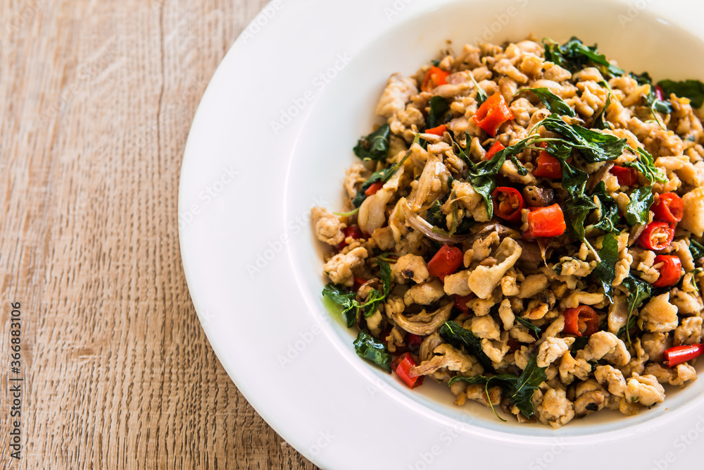 Stir fried chicken with basil, Thai famous street food Stir fried chicken with basil, Thai famous street food