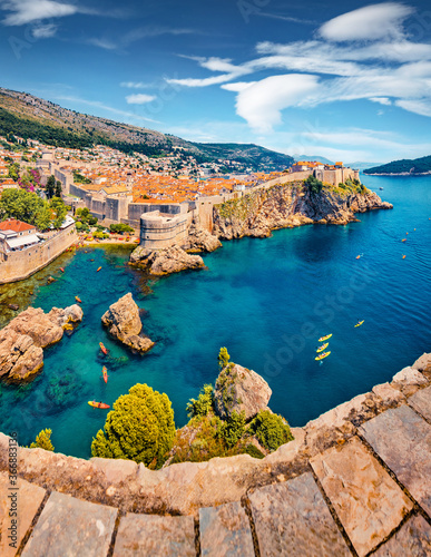 Fototapeta Naklejka Na Ścianę i Meble -  Aerial view of Old Town from Fort Bokar. Picturesque morning cityscape of Dubrovnik. Sunny summer seascape of Adriatic sea, Croatia, Europe. Beautiful world of Mediterranean countries.