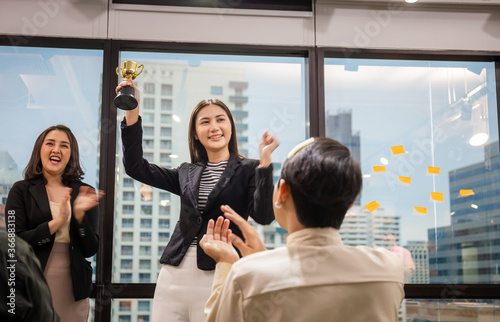 Business woman holding award trophy at meeting room, Celebration success happiness team concept © JU.STOCKER
