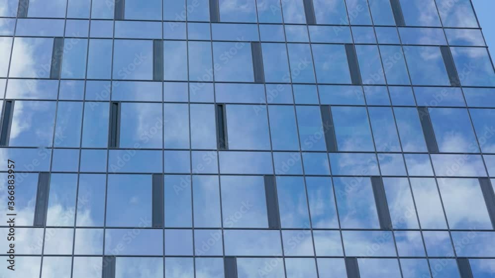 white clouds float on blue sky reflecting in downtown skyscraper panoramic windows on summer day time lapse zoom in white clouds float on blue sky reflecting in downtown skyscraper panoramic windows on summer day time lapse zoom in