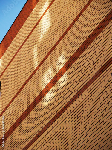 Bricks wall with square shadows photo