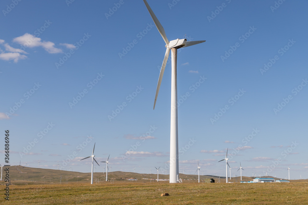 wind turbine, or wind energy converter, converts the wind's kinetic energy into electrical energy in Huanghuagou Huitengxile near Hohhot, Inner Mongolia, China, with horse, clouds and blue sky wind turbine, or wind energy converter, converts the wind's kinetic energy into electrical energy in Huanghuagou Huitengxile near Hohhot, Inner Mongolia, China, with horse, clouds and blue sky
