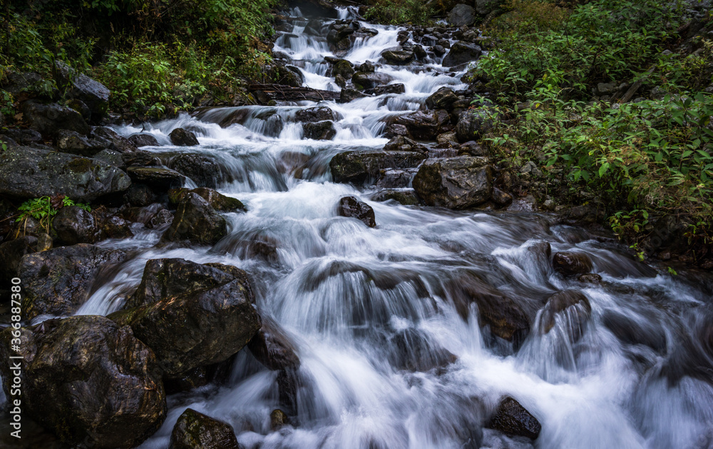 A waterfall amid foliage in Langtang National Park in Nepal. Freshwater source.