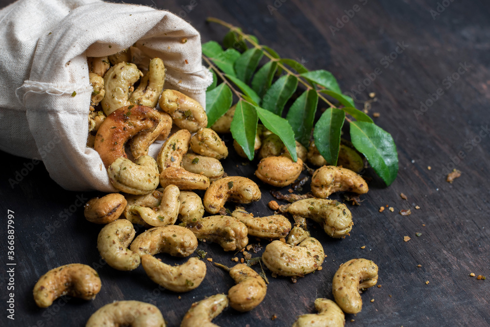 cashew nuts on a wooden background with coriander cashew nuts on a wooden background with coriander