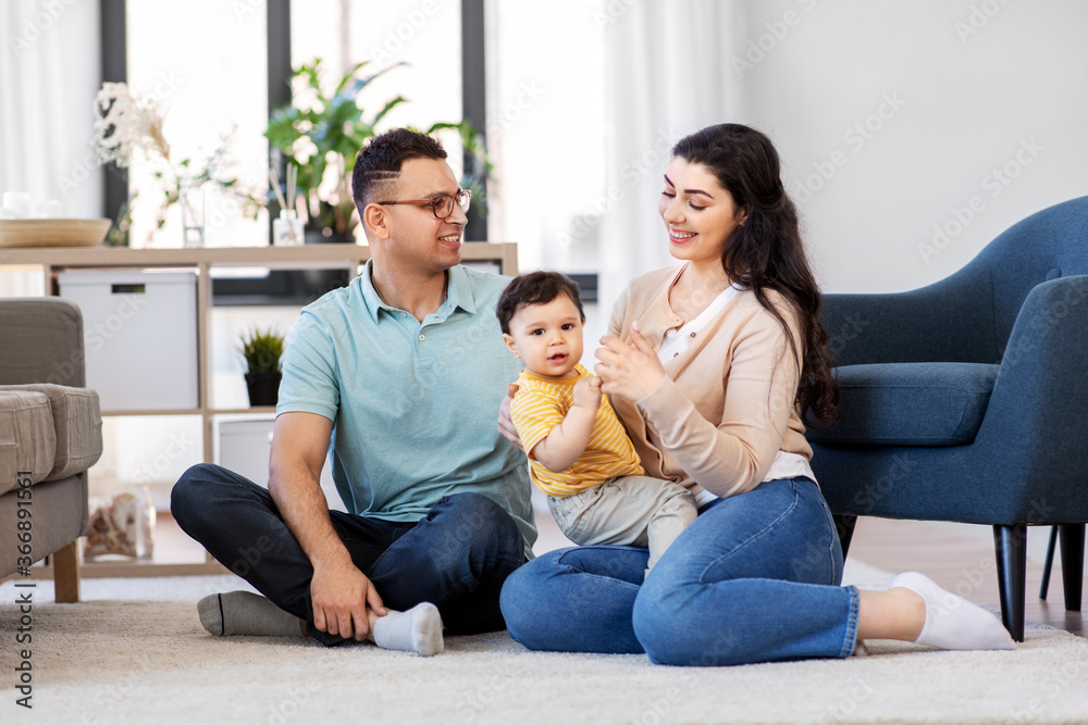 family and people concept - happy mother, father and baby son sitting on floor at home family and people concept - happy mother, father and baby son sitting on floor at home