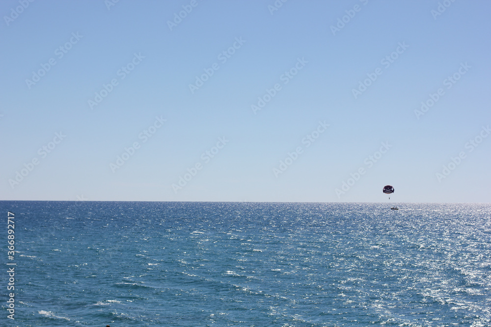 Alanya, TURKEY - August 10, 2013: Travel to Turkey. Parasailing. Active type of recreation at the sea. Parachute flights behind a boat.