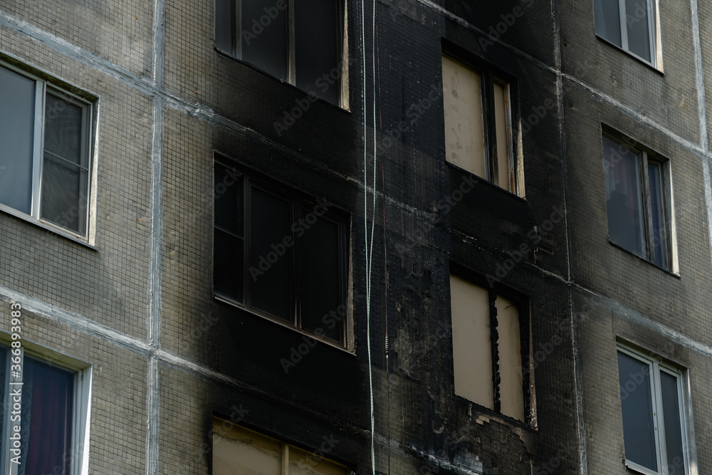 consequences of a fire in a residential building. Soot on the facade of the building consequences of a fire in a residential building. Soot on the facade of the building