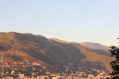 Alanya, TURKEY - August 10, 2013: Travel to Turkey. Helene Hills. Mountains in the background in the distance. Rocks, wildlife of Turkey. Forest and clear blue sky. Mediterranean Sea.