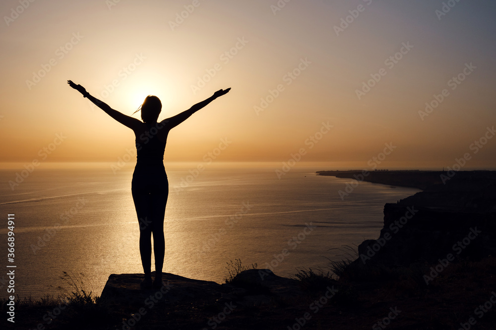 strong confidence woman open arms under the sunrise at seaside